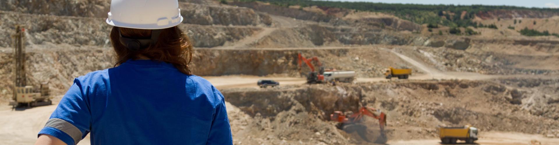 A woman at an open pit mine