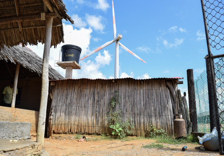 A Wayúu community house borders a wind turbine in Cabo de la Vela, Uribia.